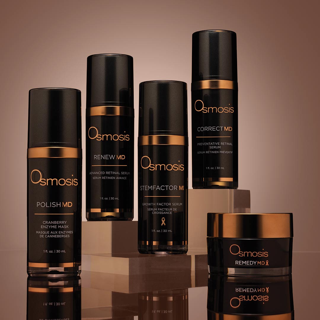 black and bronze bottles of osmosis md advanced beauty products on blush background